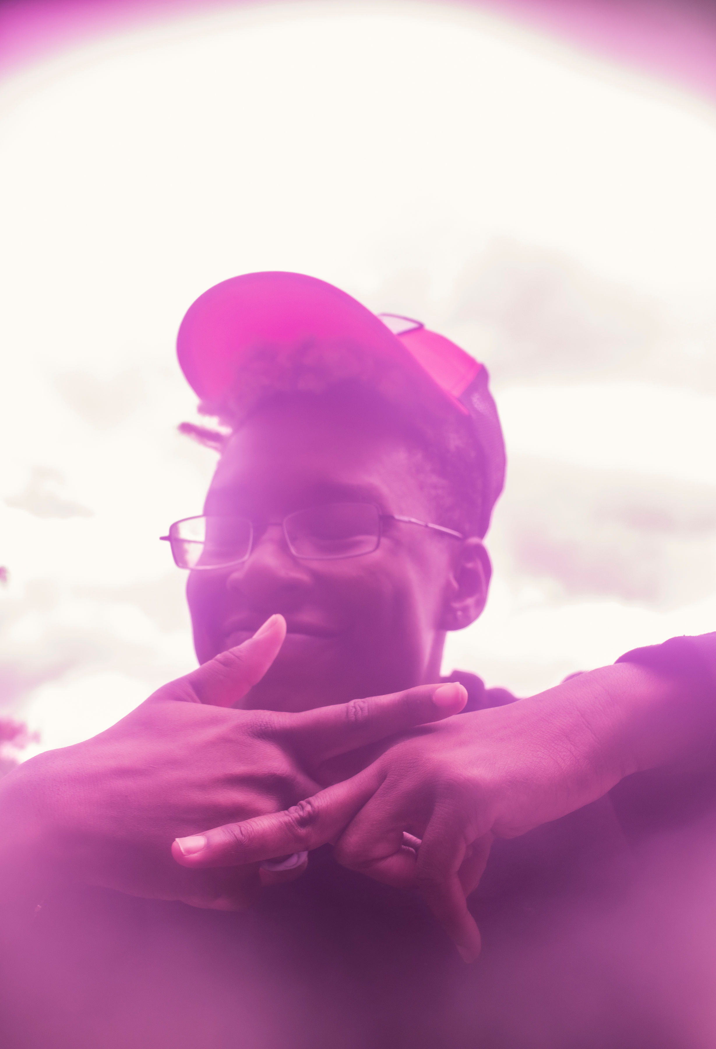 Photograph of me in a pink haze.